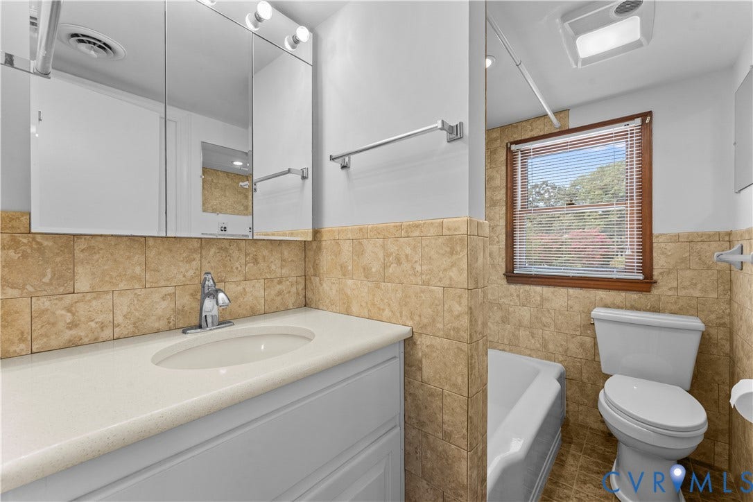 11612 Yorkdale Drive, Rivers Edge, North Prince George, VA 23860 White vanity with an integrated sink, polished chrome faucet, and triple mirrored medicine cabinet with integrated lighting