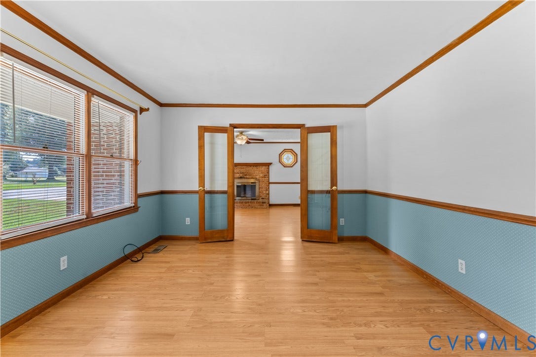 11612 Yorkdale Drive, Rivers Edge, North Prince George, VA 23860 Spacious dining room featuring original wood-trim architectural details, hardwood flooring throughout, and two-tone wall treatment with blue-gray lower paneling