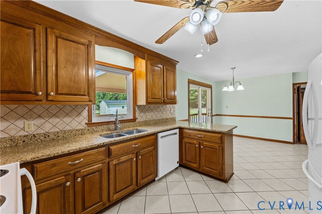 11612 Yorkdale Drive, Rivers Edge, North Prince George, VA 23860 Kitchen featuring wood cabinetry, granite-style countertops, and a tiled backsplash
