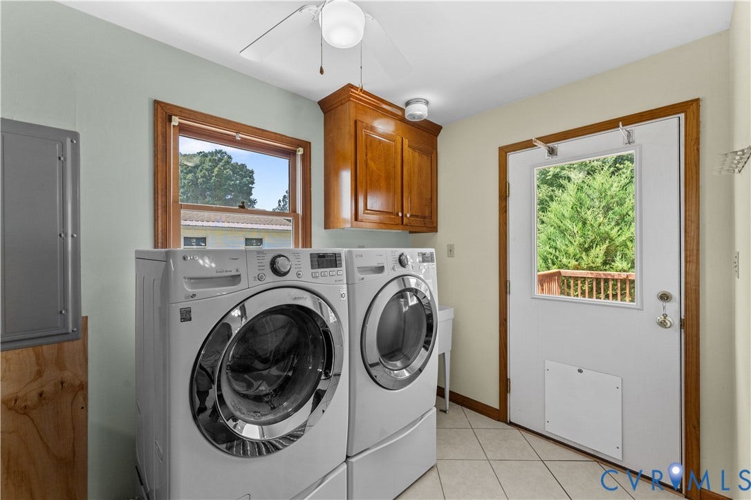 11612 Yorkdale Drive, Rivers Edge, North Prince George, VA 23860 Utility room with ceramic tile flooring, upper wood-finish cabinetry, a window, and an exterior door with a window pane