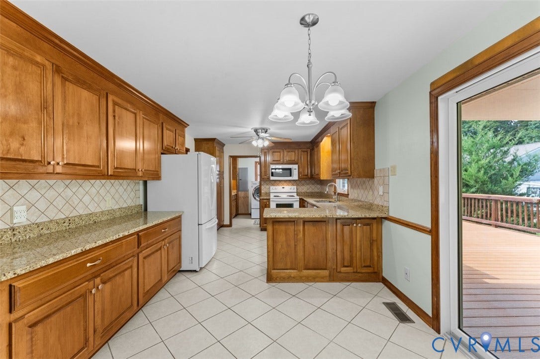 11612 Yorkdale Drive, Rivers Edge, North Prince George, VA 23860 Kitchen featuring wood cabinetry, granite-style countertops, white tile flooring, and a sliding glass door to an exterior deck