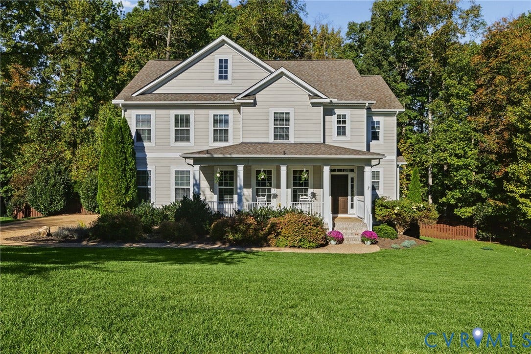 1425 Montcroft Way, Midlothian, VA 23112 Two-story residence featuring light-toned horizontal siding, a covered front porch with column supports, a gabled roofline, and an expansive lawn
