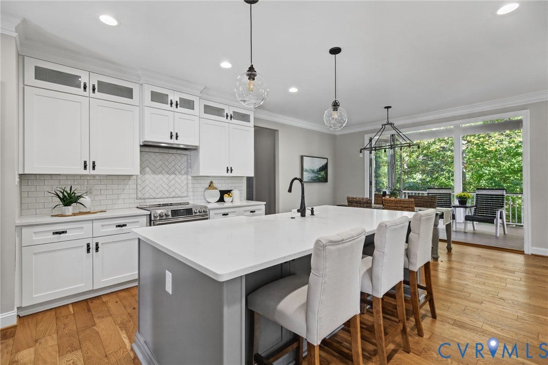 1425 Montcroft Way, Midlothian, VA 23112 Kitchen featuring white shaker-style cabinetry with glass-front uppers, a central island with a contrasting base and solid-surface countertop, white subway tile backsplash in a herringbone pattern, wood-finish flooring, and pendant lighting