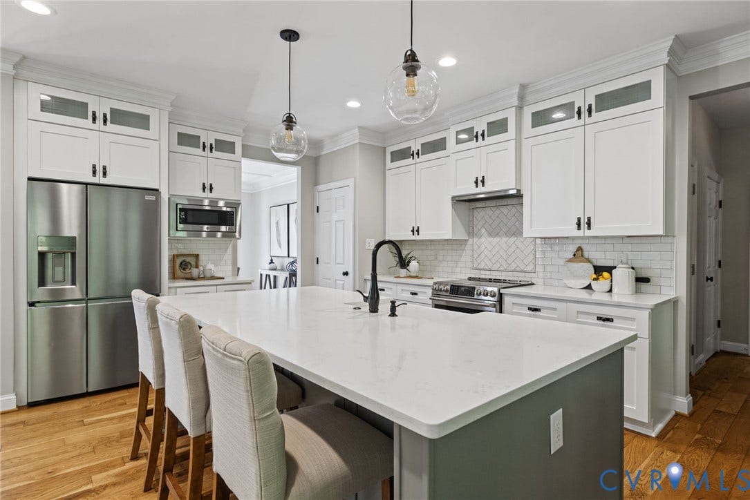 1425 Montcroft Way, Midlothian, VA 23112 Kitchen featuring white cabinetry with glass-front uppers, a central island with a quartz countertop, stainless steel appliances, herringbone-pattern tile backsplash, and wood-finish flooring