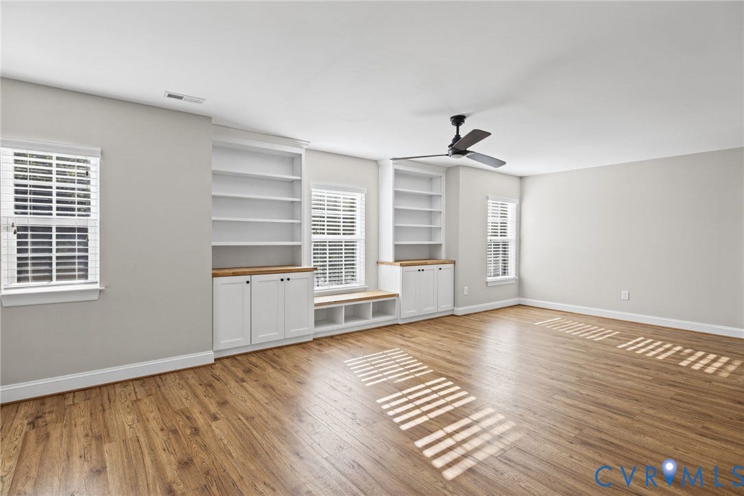 1425 Montcroft Way, Midlothian, VA 23112 Wood-finish flooring, built-in shelving with lower cabinetry, integrated bench seating, multi-pane windows with white frames, and a ceiling-mounted fan