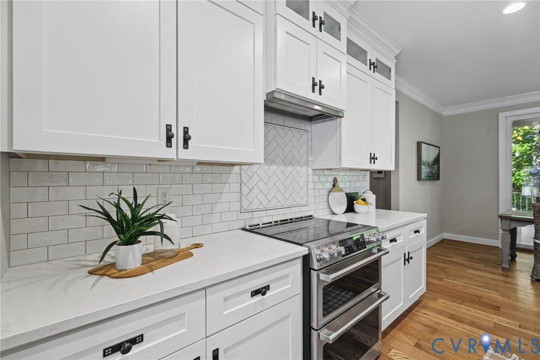 1425 Montcroft Way, Midlothian, VA 23112 Kitchen featuring white Shaker-style cabinetry, quartz countertops, subway tile backsplash with herringbone detailing, stainless steel double oven, and wood-finish flooring