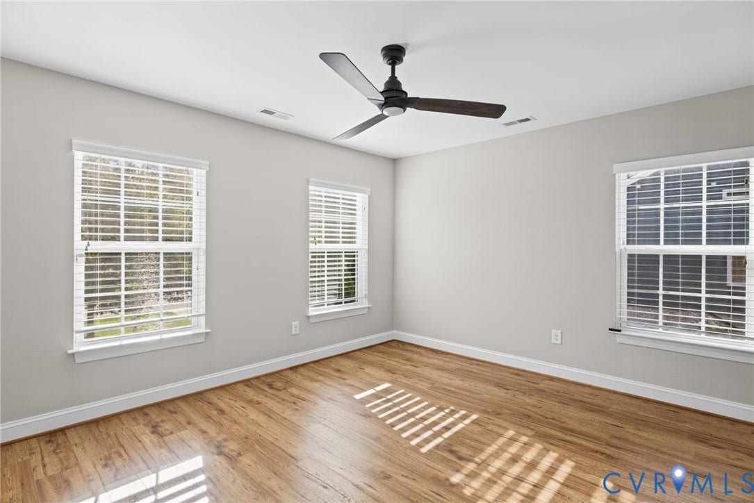 1425 Montcroft Way, Midlothian, VA 23112 Room featuring wood-finish flooring, three windows with horizontal blinds, and a matte black ceiling fan