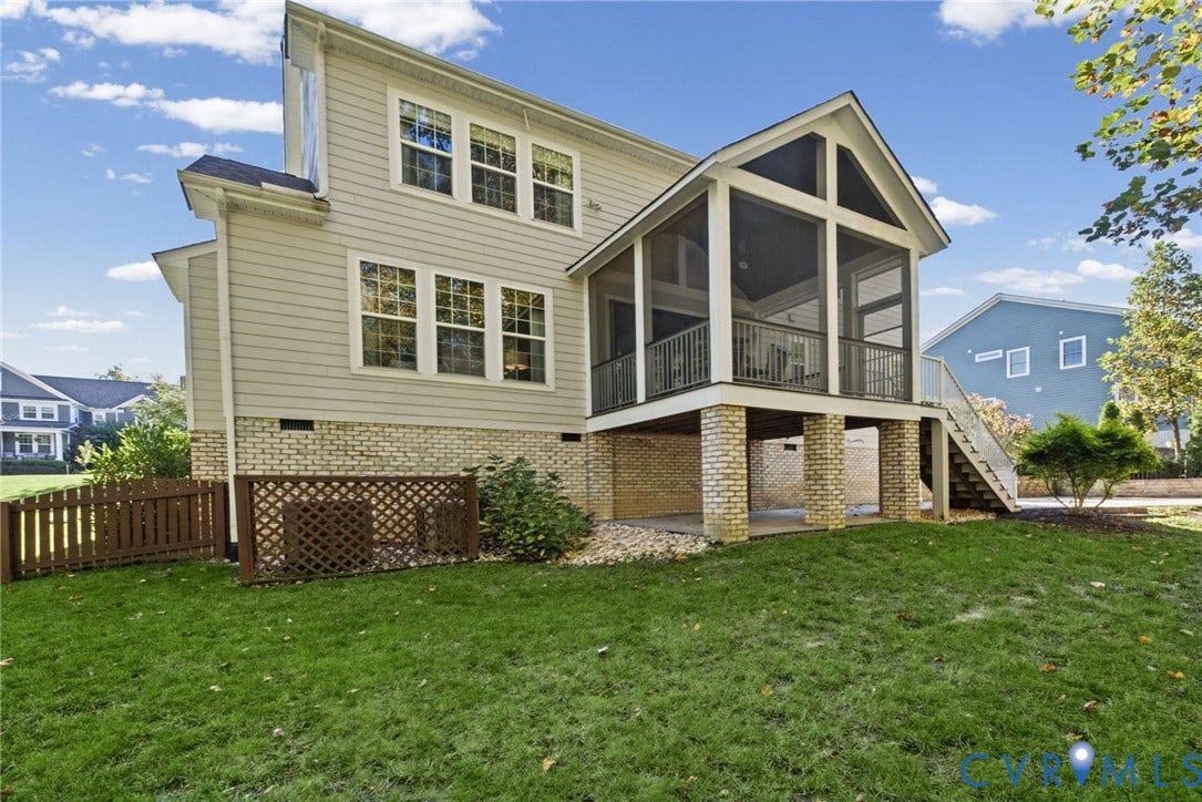 1425 Montcroft Way, Midlothian, VA 23112 Rear exterior featuring horizontal lap siding, a brick foundation, a screened porch with a gable roof, and a wooden privacy lattice