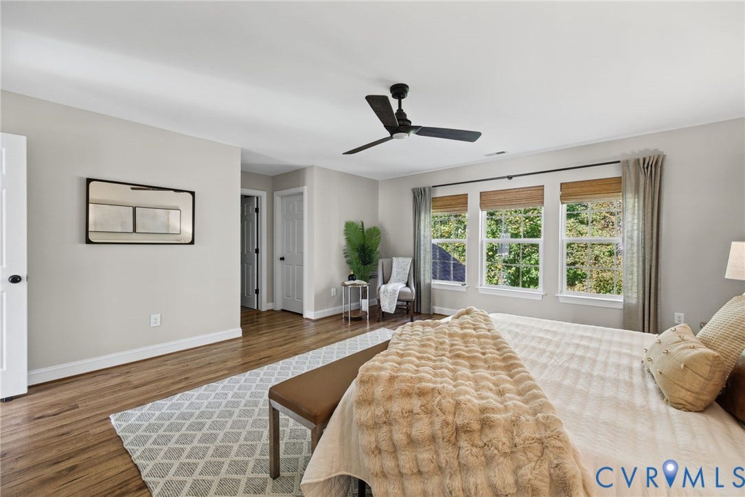 1425 Montcroft Way, Midlothian, VA 23112 Neutral wall tones, wood-finish flooring, trio of windows, and matte black ceiling fan