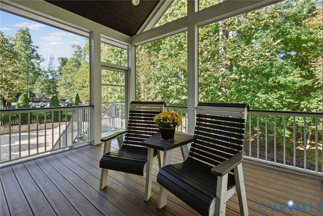 1425 Montcroft Way, Midlothian, VA 23112 Screened porch featuring wood-finish decking, white railings, vaulted ceiling, and floor-to-ceiling windows