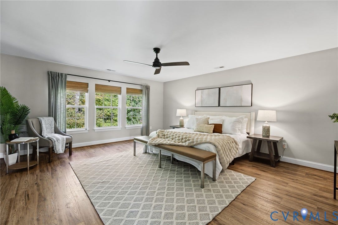 1425 Montcroft Way, Midlothian, VA 23112 Spacious room featuring wood-finish flooring, a matte black ceiling fan, and triple windows with integrated wooden blinds
