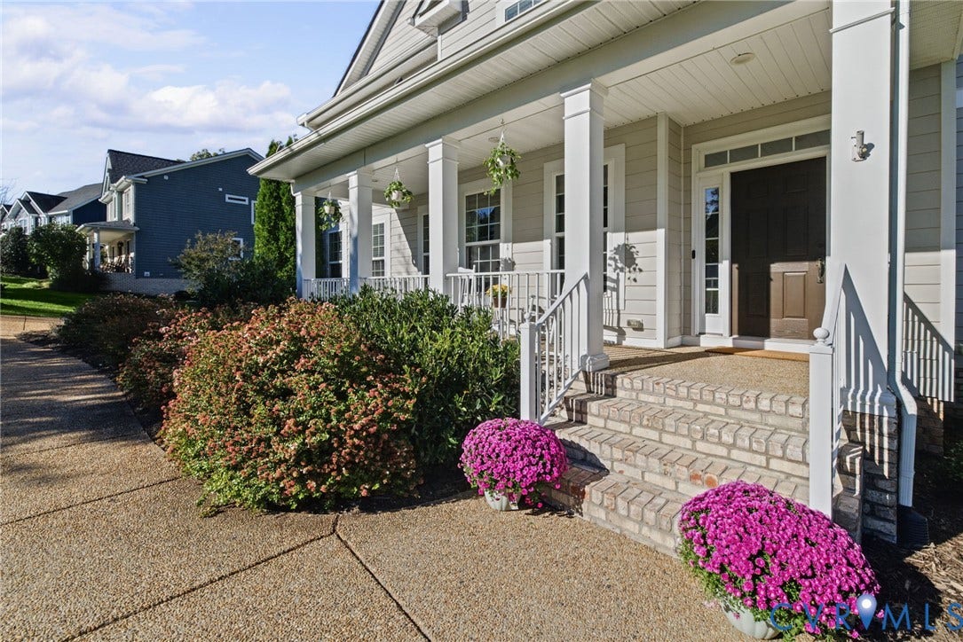 1425 Montcroft Way, Midlothian, VA 23112 Covered front porch featuring white structural columns, a brick-tread staircase, horizontal lap siding, and multi-pane transom windows above the entryway
