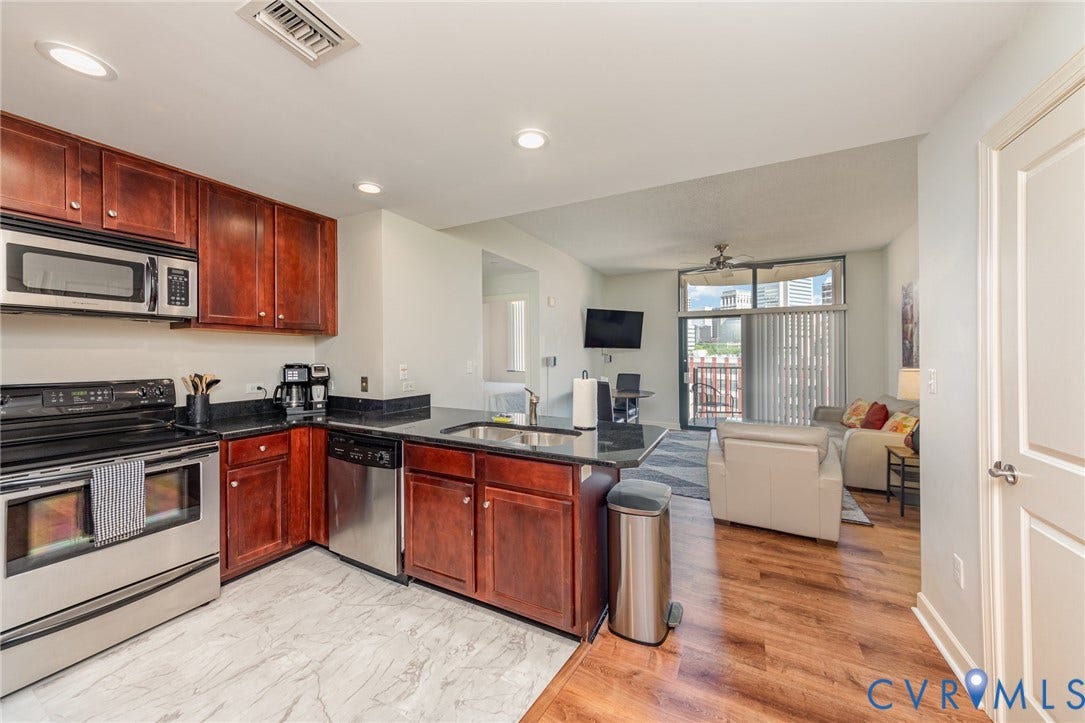 1101 Haxall Point, #709, Richmond, VA 23219 Kitchen featuring dark wood cabinetry, stainless steel appliances, and dark countertops