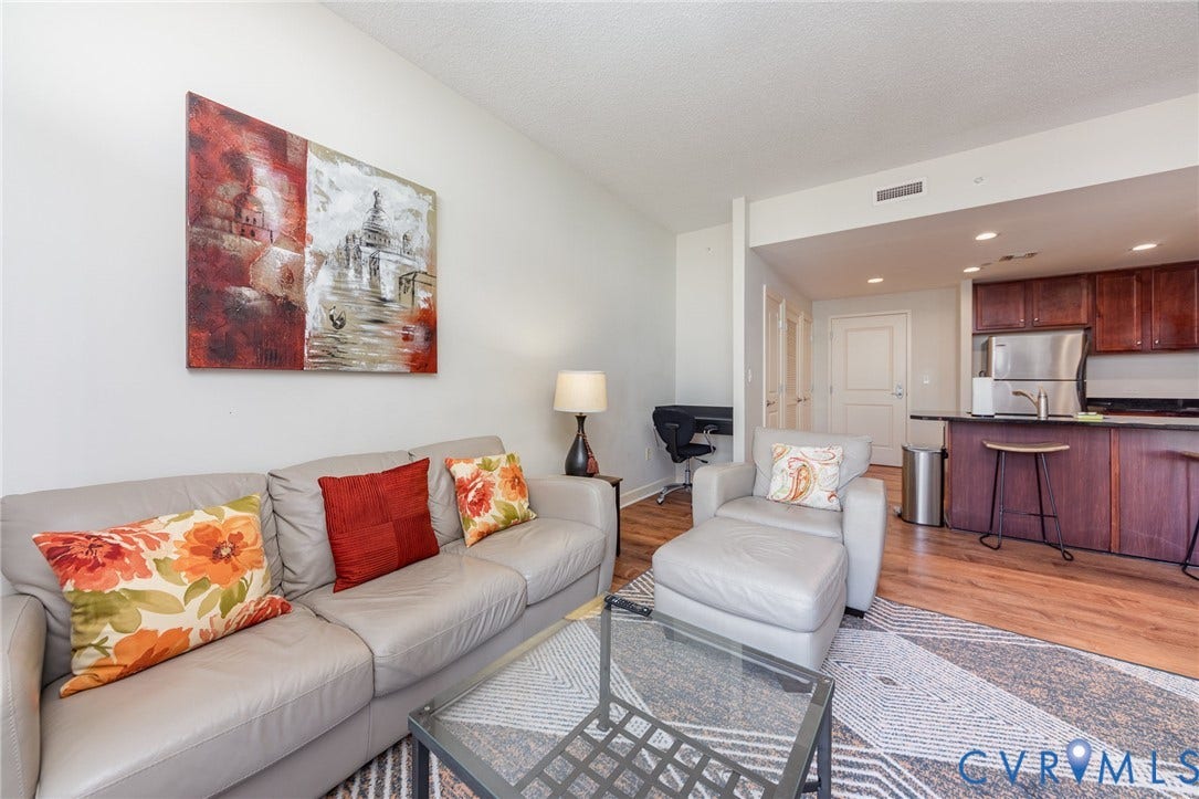 1101 Haxall Point, #709, Richmond, VA 23219 Open-concept living space with wood-finish flooring, vaulted ceilings, and recessed lighting