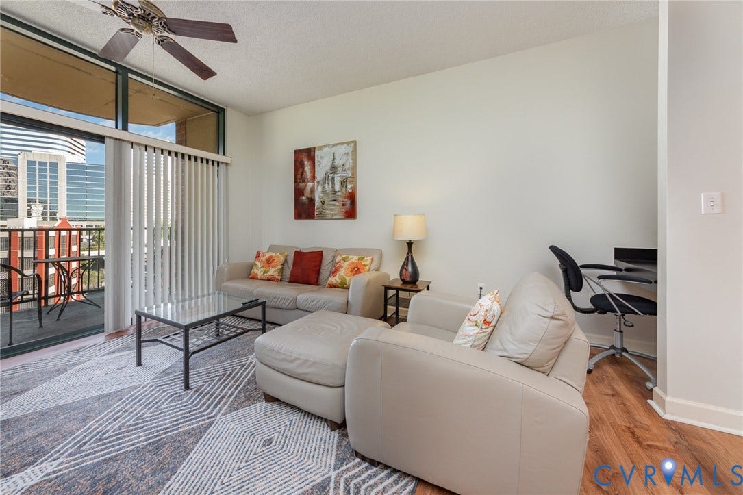 1101 Haxall Point, #709, Richmond, VA 23219 Living area featuring a ceiling fan, sliding glass doors to a balcony, and wood-finish flooring