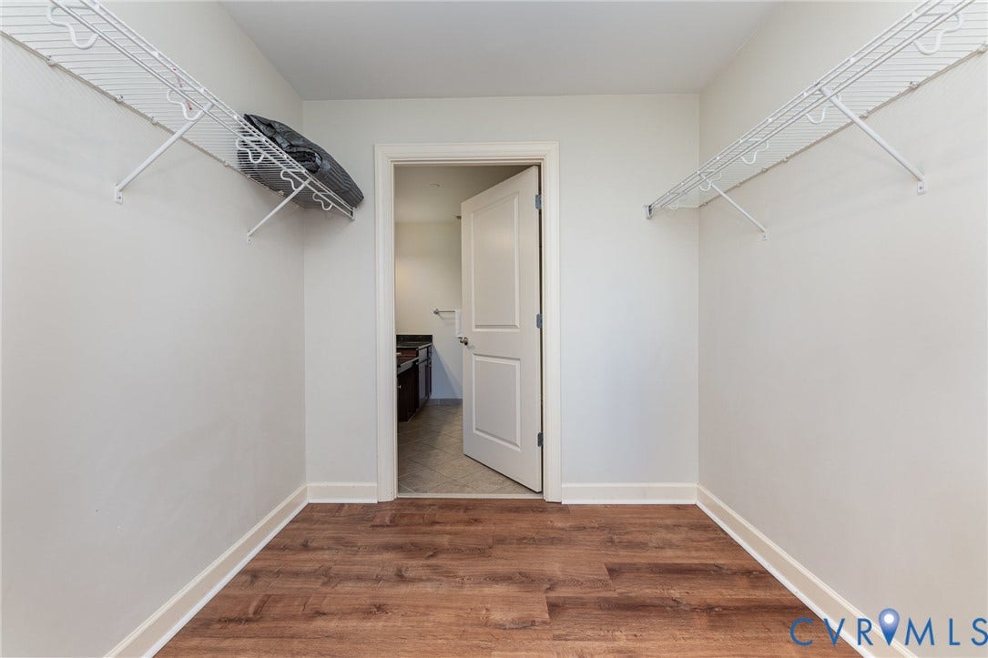 1101 Haxall Point, #709, Richmond, VA 23219 Walk-in closet with wood-finish flooring, white wire shelving, and light-colored walls