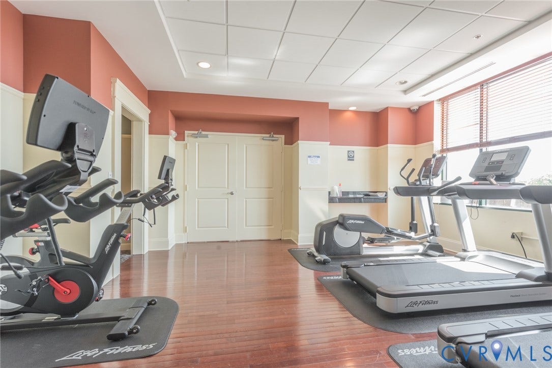 1101 Haxall Point, #709, Richmond, VA 23219 Dedicated fitness space featuring wood-finish flooring, large windows with blinds, and recessed lighting