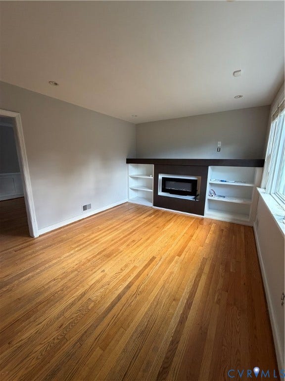 4612 Cutshaw Avenue, Richmond, VA 23230 Room featuring wood-finish flooring, recessed lighting, and a built-in fireplace mantle with integrated white shelving