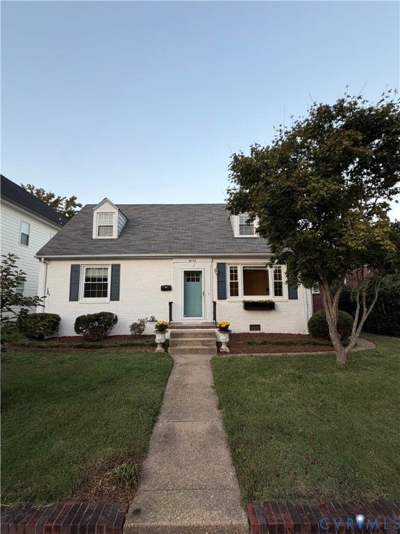 4612 Cutshaw Avenue, Richmond, VA 23230 Cape Cod exterior featuring a painted brick facade, two dormer windows, shuttered multi-pane windows, and a concrete walkway