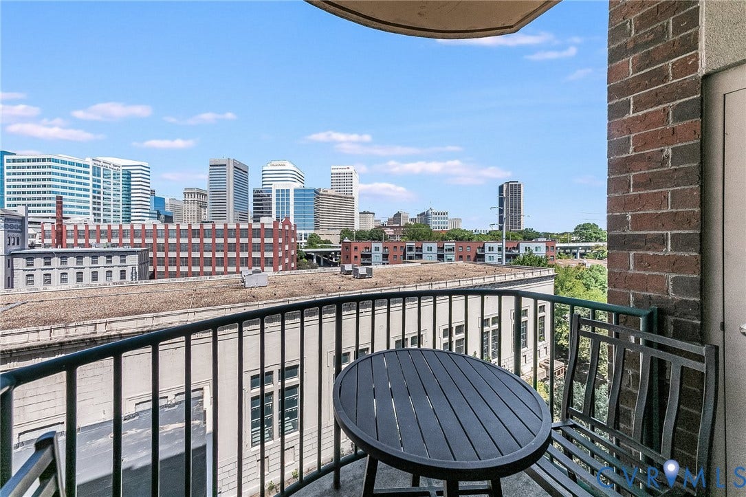 1101 Haxall Point, #511, Richmond, VA 23219 Balcony featuring a metal railing and brick exterior wall