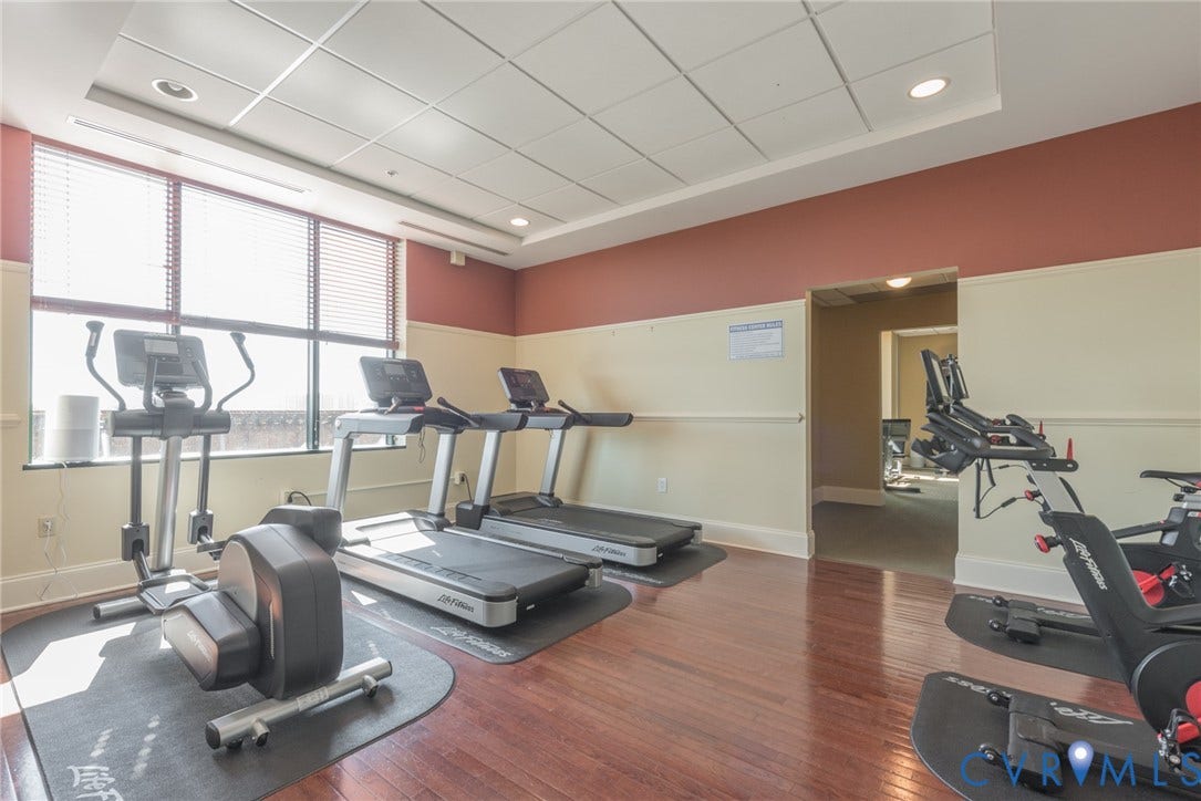 1101 Haxall Point, #511, Richmond, VA 23219 Fitness area featuring wood-finish flooring, drop ceiling with recessed lighting, and large windows with blinds