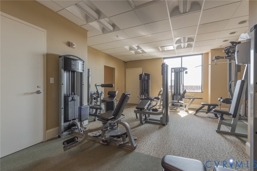 1101 Haxall Point, #511, Richmond, VA 23219 Fitness center featuring multiple exercise machines, carpeted flooring, and large windows