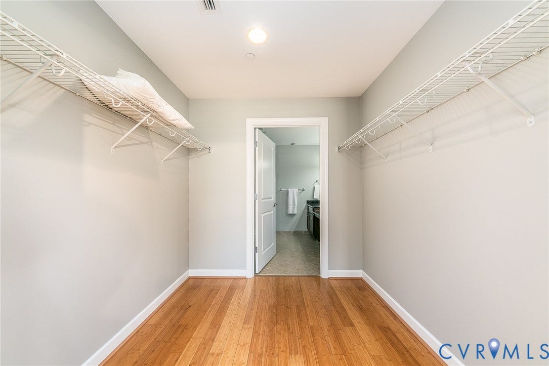 1101 Haxall Point, #511, Richmond, VA 23219 Hardwood flooring with white baseboards, recessed lighting, and wire shelving