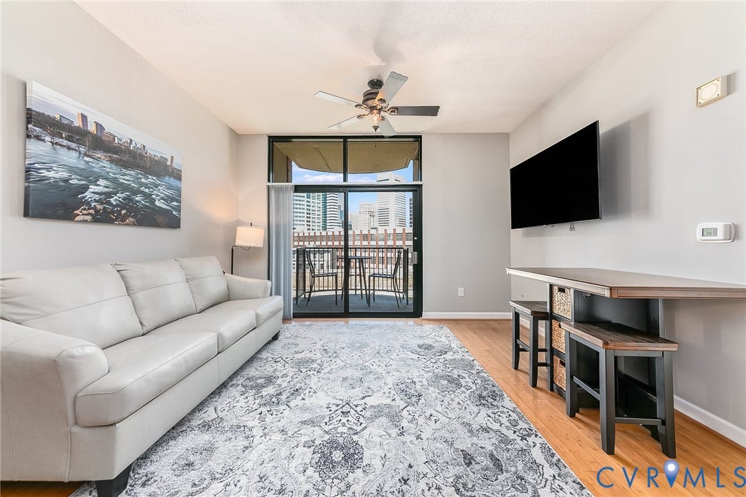 1101 Haxall Point, #511, Richmond, VA 23219 Balcony access featuring sliding glass doors, a ceiling fan, and wood-finish flooring