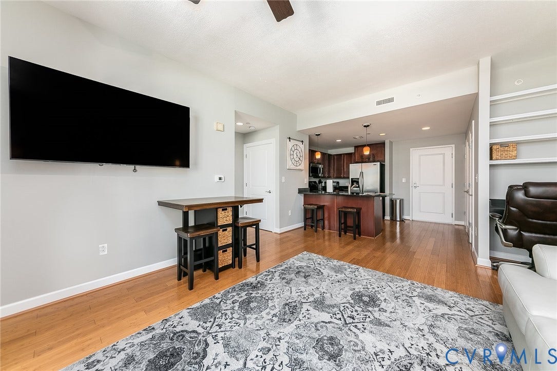 1101 Haxall Point, #511, Richmond, VA 23219 Wood-finish flooring, recessed lighting, built-in shelving, stainless steel appliances, and dark wood cabinetry