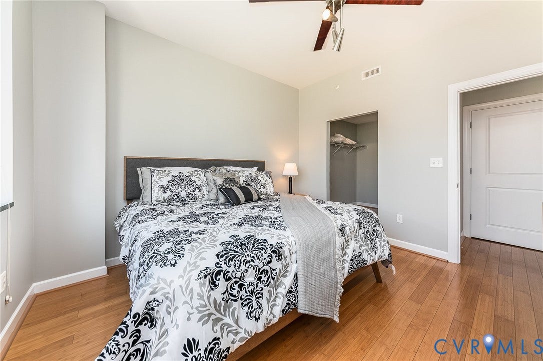 1101 Haxall Point, #511, Richmond, VA 23219 Wood-finish flooring, recessed open closet, ceiling fan, and light-toned wall paint