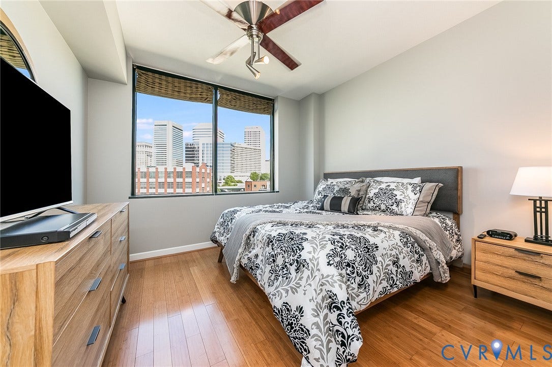 1101 Haxall Point, #511, Richmond, VA 23219 Hardwood flooring throughout, large windows with city scenery, and a ceiling fan with integrated lighting