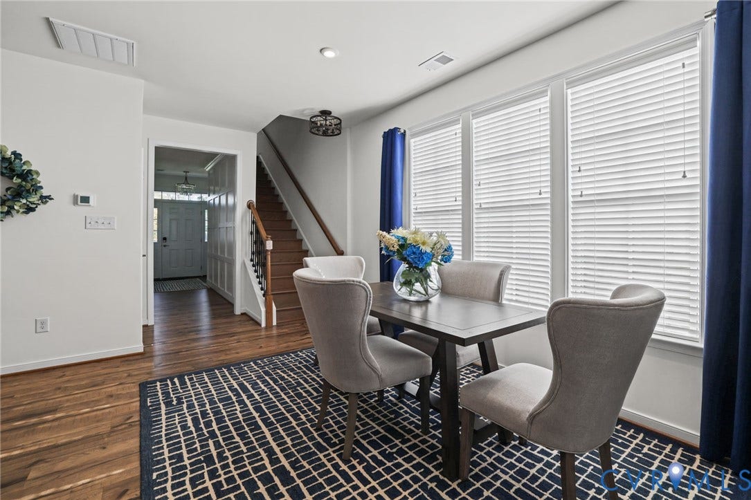 9337 Citrine Run, Henrico, VA 23238 Wood-finish flooring, staircase with a wood handrail, and large windows with horizontal blinds