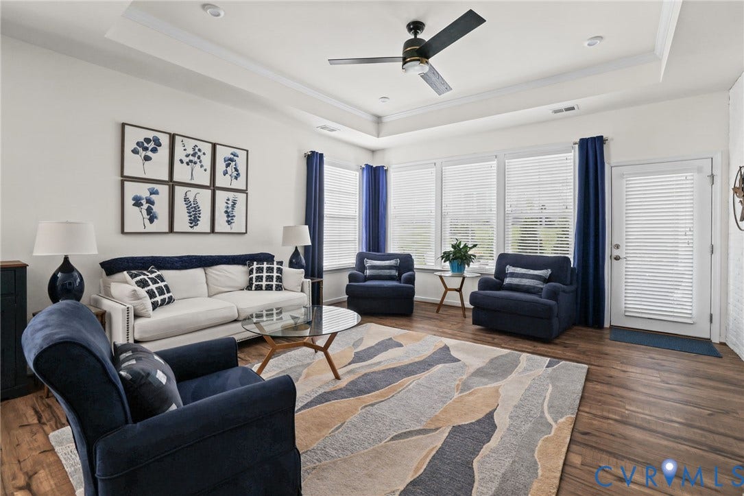 9337 Citrine Run, Henrico, VA 23238 Living area featuring tray ceilings, wood-finish flooring, recessed lighting, a modern ceiling fan, and large windows with integrated blinds