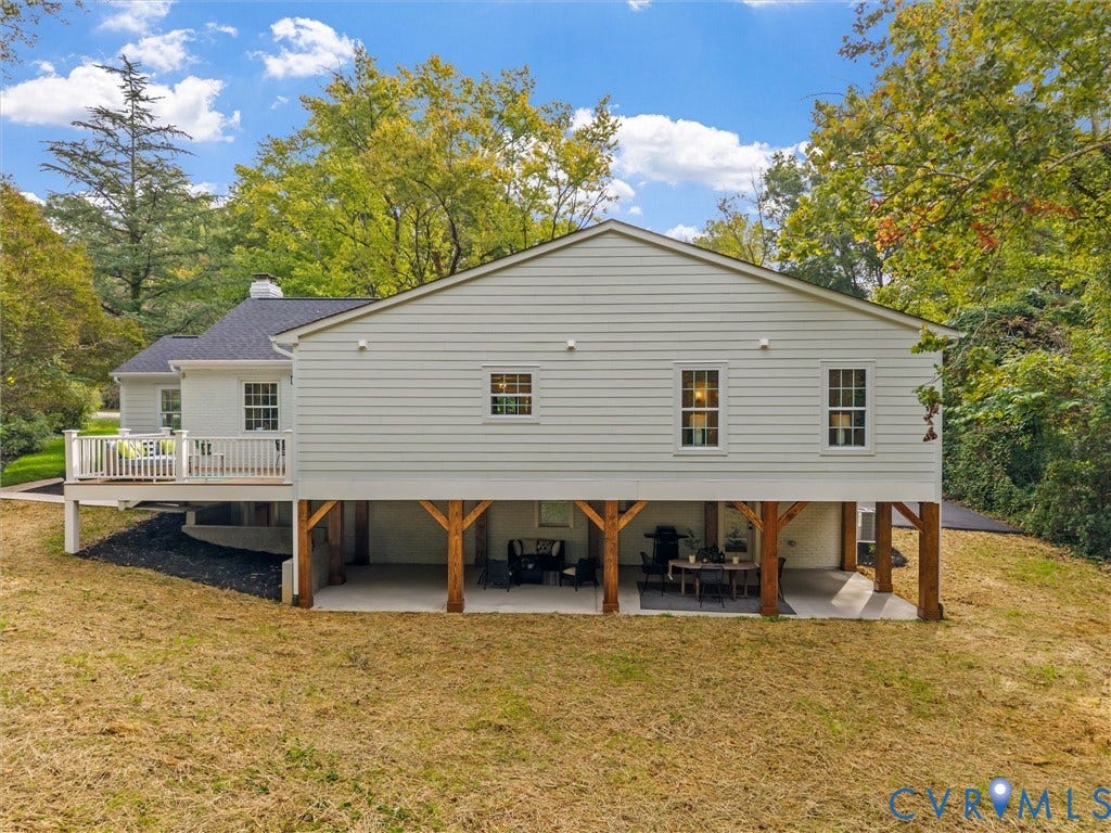 702 Westham Parkway, Westham, Henrico, VA 23229 Siding exterior with multiple windows, elevated deck with white railings, and a covered patio area with exposed structural beams