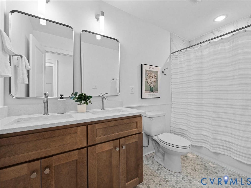 702 Westham Parkway, Westham, Henrico, VA 23229 Dual rectangular mirrors above a wood-finish vanity with dual sinks and white countertops