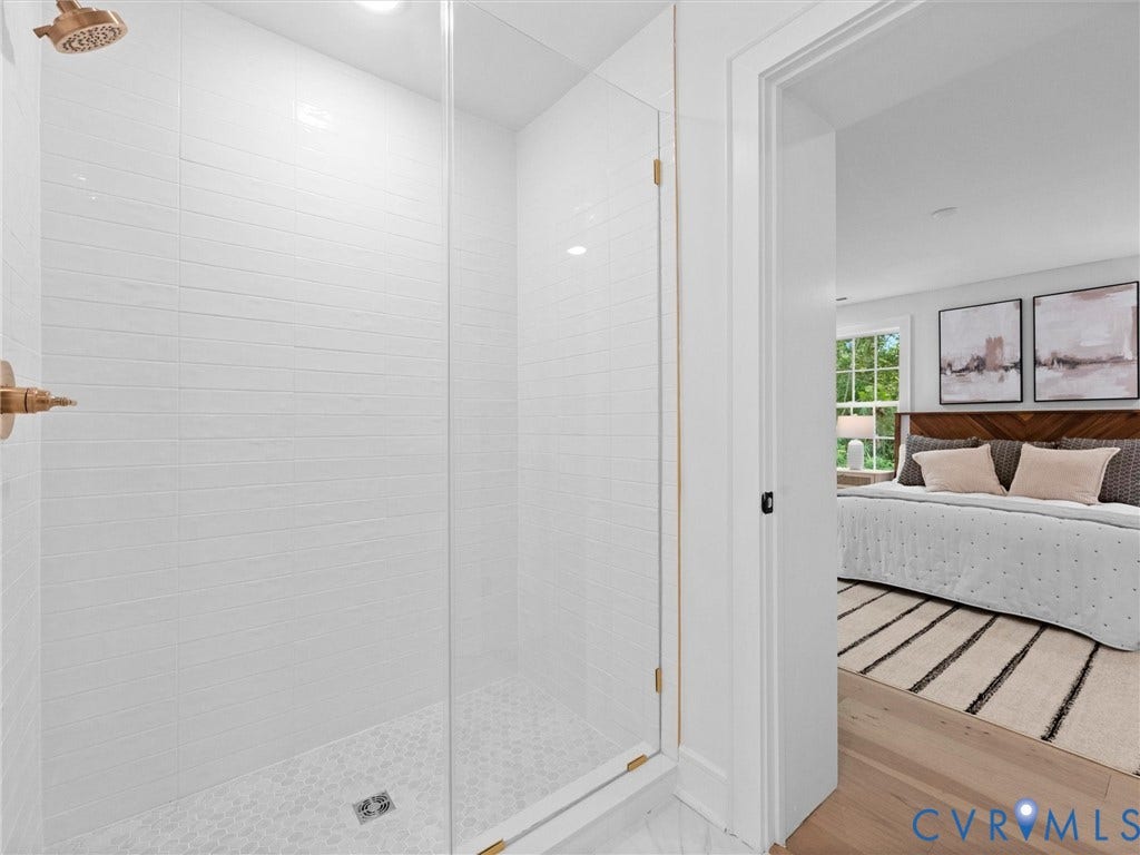 702 Westham Parkway, Westham, Henrico, VA 23229 Glass-enclosed shower with white tiled walls and a hex-tile shower pan