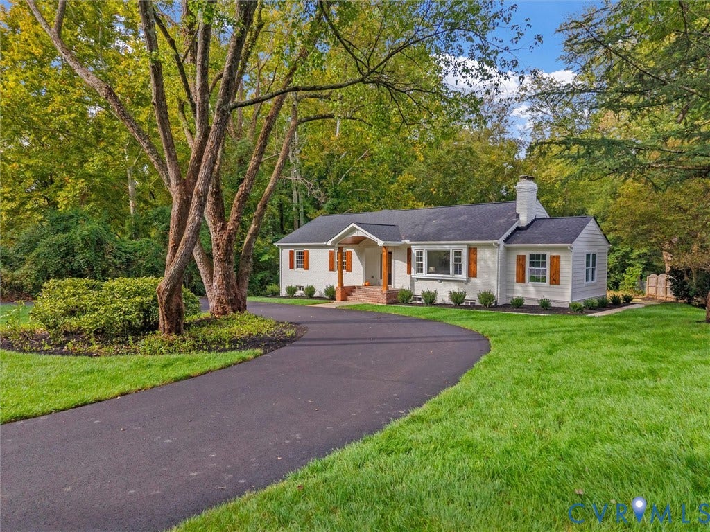 702 Westham Parkway, Westham, Henrico, VA 23229 White siding exterior with a dark roof and chimney, featuring natural wood shutters and a prominent front porch with exposed wood beams