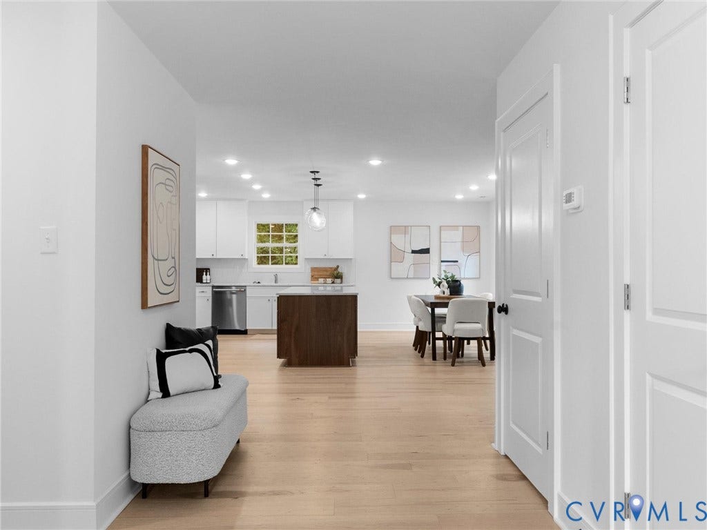 702 Westham Parkway, Westham, Henrico, VA 23229 Wood-finish flooring throughout, recessed lighting, white interior doors with dark hardware, white kitchen cabinetry with stainless steel appliances, and a wood-finish kitchen island