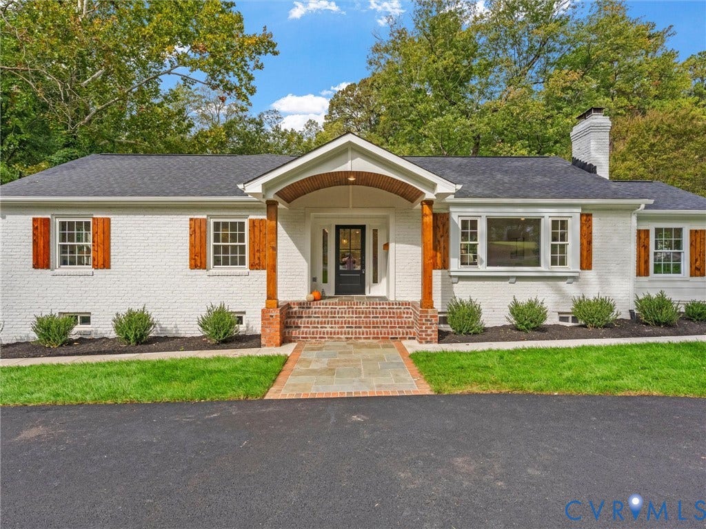 702 Westham Parkway, Westham, Henrico, VA 23229 White brick exterior with a dark shingle roof, wood shutters, and an inviting front porch with brick stairs