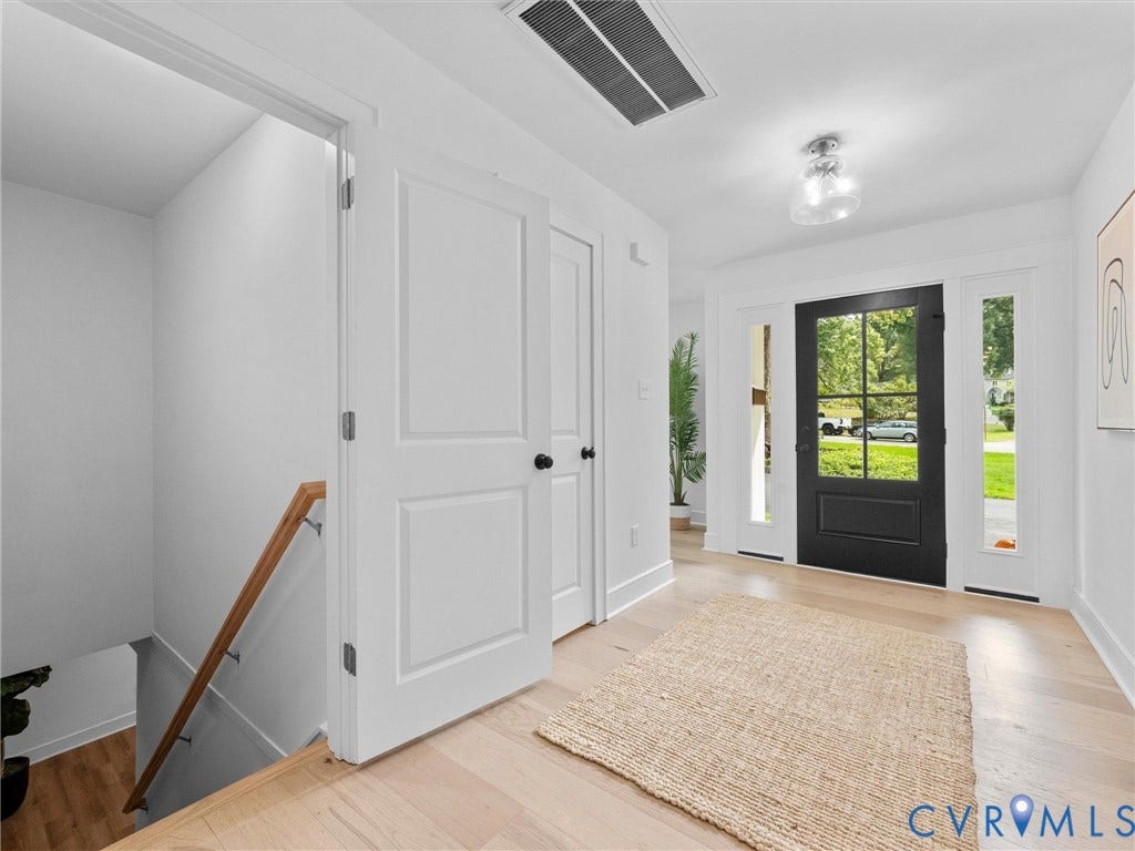 702 Westham Parkway, Westham, Henrico, VA 23229 Foyer with light wood-finish flooring, a black paneled door with glass inserts, and flanking sidelights