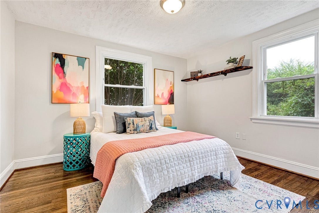 2817 Groveland Avenue, Green Park, Richmond, VA 23222 Light-colored walls with wood-finish flooring, featuring two windows, a ceiling-mounted light fixture, and a wall-mounted shelf
