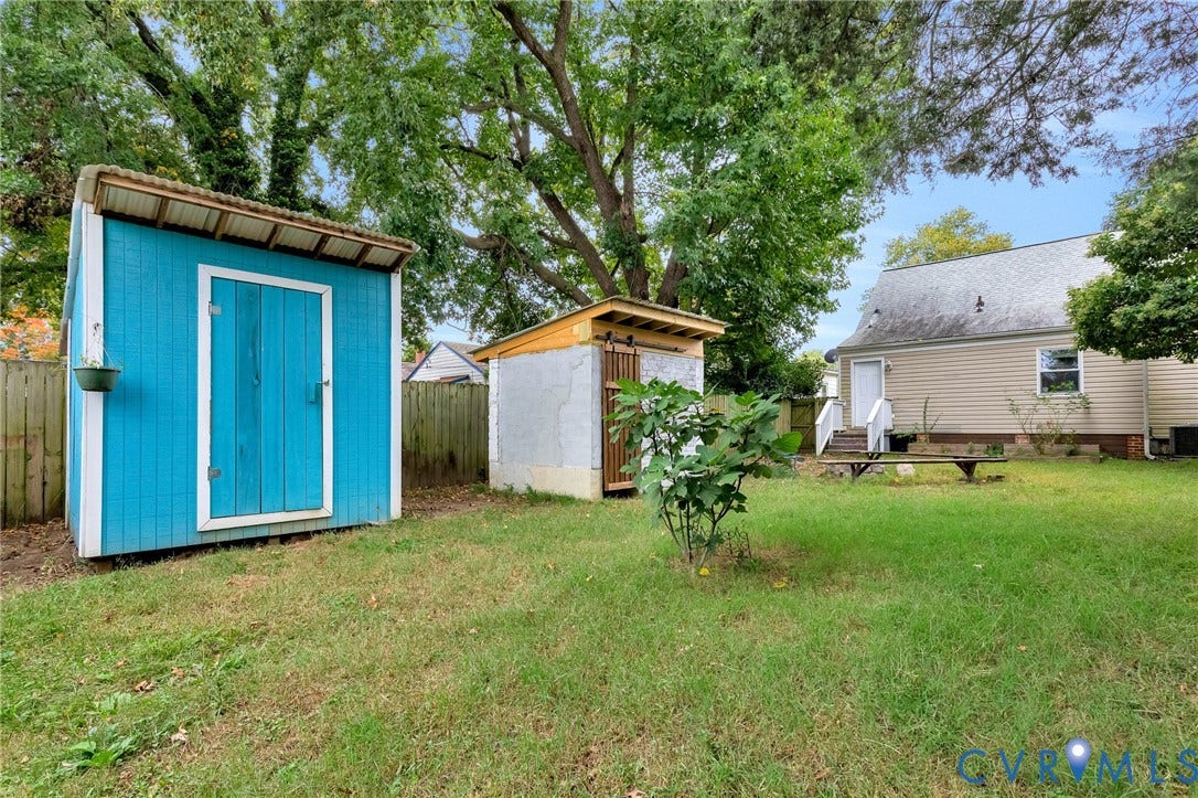 2817 Groveland Avenue, Green Park, Richmond, VA 23222 Expansive yard featuring two storage sheds, wood fencing, and mature trees