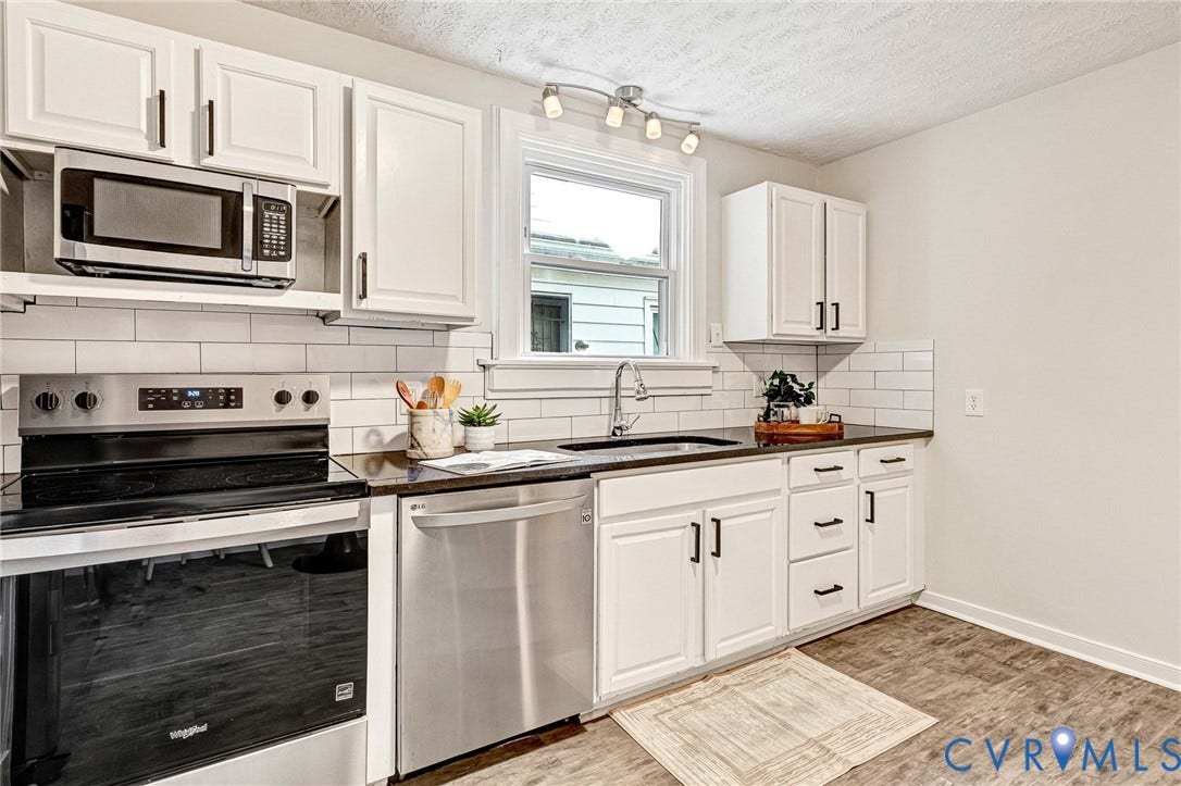 2817 Groveland Avenue, Green Park, Richmond, VA 23222 White cabinetry, subway tile backsplash, dark countertops, stainless steel appliances, and wood-finish flooring