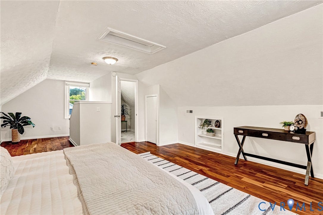 2817 Groveland Avenue, Green Park, Richmond, VA 23222 Hardwood flooring, sloped ceiling, built-in shelving, white walls, and a window for natural light