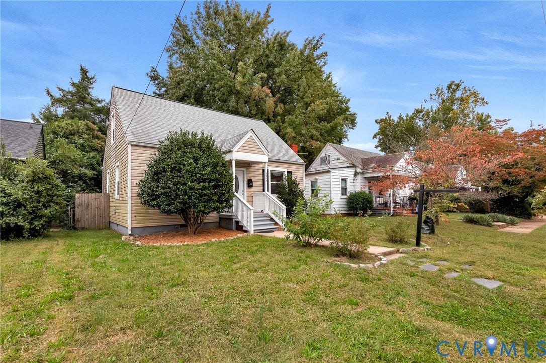 2817 Groveland Avenue, Green Park, Richmond, VA 23222 Gable roofline, beige siding exterior, white porch columns, white porch railings, and a front yard with mature shrubbery