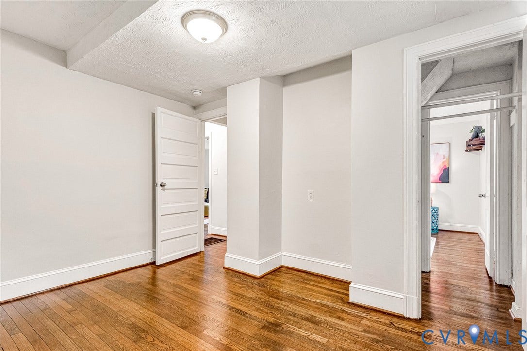 2817 Groveland Avenue, Green Park, Richmond, VA 23222 Hardwood flooring, painted walls, white trim, flush mount ceiling light, and a closet with a hanging rod