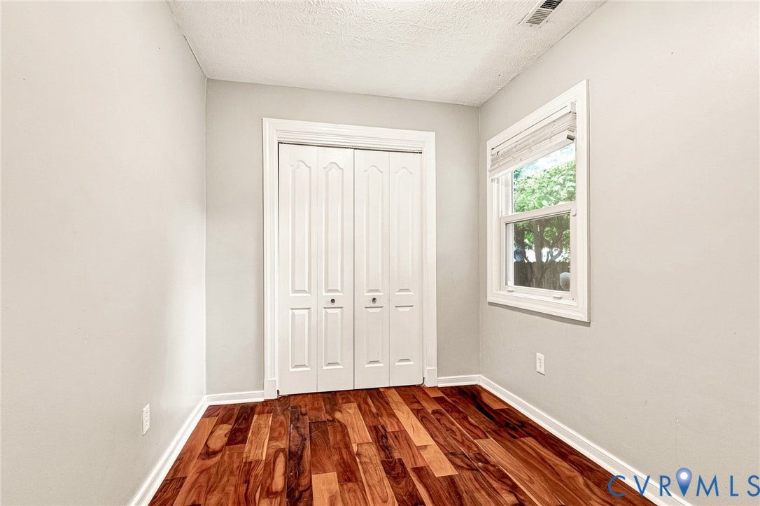 2817 Groveland Avenue, Green Park, Richmond, VA 23222 Hardwood flooring, painted walls, white trim, bi-fold closet doors, and window with blinds