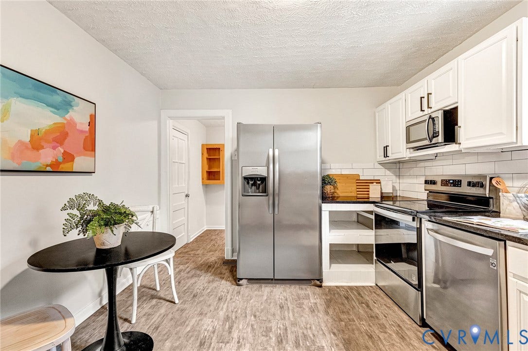 2817 Groveland Avenue, Green Park, Richmond, VA 23222 Kitchen featuring stainless steel appliances, white cabinetry with dark hardware, white subway tile backsplash, and wood-finish flooring