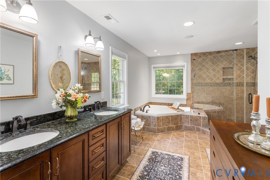 12380 Bienvenue Road, Bowles Acres, Rockville, VA 23146 Dual-sink vanity granite countertops, wood-finish cabinetry, recessed lighting, corner jetted tub, and a tiled walk-in shower with a glass enclosure private water closet.
