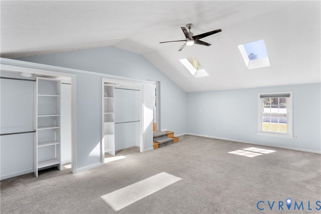 12380 Bienvenue Road, Bowles Acres, Rockville, VA 23146 Vaulted ceilings featuring two skylights, a center ceiling fan, dual built-in closets with integrated shelving, and wall-to-wall carpeting